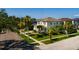 A beautiful exterior view of the two-story home featuring manicured landscaping and palm trees at 852 Cordova Ne Blvd, St Petersburg, FL 33704