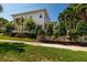 The side of this home includes a manicured lawn and garden, with a white picket fence and sidewalk visible at 852 Cordova Ne Blvd, St Petersburg, FL 33704