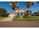 Beautiful two-story home features a manicured lawn, vibrant flowers, and a welcoming front porch at 852 Cordova Ne Blvd, St Petersburg, FL 33704