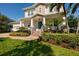 Charming two-story home with landscaped front yard, covered porch, and inviting turquoise front door at 852 Cordova Ne Blvd, St Petersburg, FL 33704