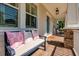 Inviting front porch with brick flooring, seating, and charming details at 852 Cordova Ne Blvd, St Petersburg, FL 33704