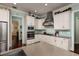Well-equipped kitchen with white cabinets, stainless steel appliances, and an island with sink at 852 Cordova Ne Blvd, St Petersburg, FL 33704
