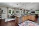Open kitchen with an island, stainless steel appliances, hardwood floors, and a casual dining area at 852 Cordova Ne Blvd, St Petersburg, FL 33704