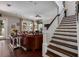 Open-concept living space with a leather sofa, cozy chairs, staircase, and ample natural light at 852 Cordova Ne Blvd, St Petersburg, FL 33704