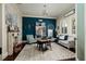 Cozy home office with a blue accent wall, decorative fireplace, and ample natural light at 852 Cordova Ne Blvd, St Petersburg, FL 33704