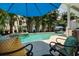 Inviting backyard pool and spa area with comfortable lounge chairs and shade umbrellas, perfect for relaxation at 852 Cordova Ne Blvd, St Petersburg, FL 33704