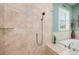 Shower with travertine tile and rainfall shower head at 852 Cordova Ne Blvd, St Petersburg, FL 33704