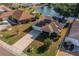 Aerial view of single-Gathering home with solar panels, well-manicured lawn, and waterfront access at 913 El Rancho Dr, Sun City Center, FL 33573
