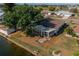 Aerial view of the backyard with an enclosed porch and lake views at 913 El Rancho Dr, Sun City Center, FL 33573