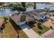 Aerial view of single-Gathering home with solar panels, manicured lawn, and access to a waterway at 913 El Rancho Dr, Sun City Center, FL 33573