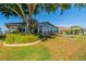 Enclosed back porch and meticulous landscaping accentuate the backyard of this home at 913 El Rancho Dr, Sun City Center, FL 33573