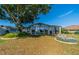 Beautiful backyard with a large tree and an enclosed back porch at 913 El Rancho Dr, Sun City Center, FL 33573