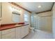 Bathroom with vanity, glass block shower, and tile flooring at 913 El Rancho Dr, Sun City Center, FL 33573