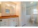 Bathroom with white vanity, built-in storage, and walk-in tub/shower at 913 El Rancho Dr, Sun City Center, FL 33573