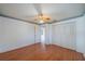 Neutral bedroom featuring wood flooring, a ceiling fan, and a closet at 913 El Rancho Dr, Sun City Center, FL 33573