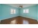 Bright bedroom with a ceiling fan and two windows at 913 El Rancho Dr, Sun City Center, FL 33573