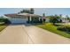 Charming single Gathering home with a well-maintained lawn and a spacious two-car garage at 913 El Rancho Dr, Sun City Center, FL 33573