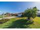 Well manicured front yard with green grass and flowering plants at 913 El Rancho Dr, Sun City Center, FL 33573