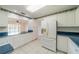 Kitchen with white cabinetry, tiled floor, modern refrigerator and eat in nook at 913 El Rancho Dr, Sun City Center, FL 33573