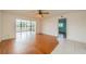 Bright sunroom featuring wood floors, water views, and access to the lanai at 913 El Rancho Dr, Sun City Center, FL 33573