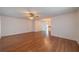 Spacious living room with hardwood floors, ceiling fan, and views of the dining area at 913 El Rancho Dr, Sun City Center, FL 33573