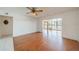Bright living room featuring wood floors, ceiling fan, and sunroom access with lake view at 913 El Rancho Dr, Sun City Center, FL 33573