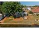 Waterfront home featuring a screen enclosed porch with tranquil water views and mature tree shading on a sunny day at 913 El Rancho Dr, Sun City Center, FL 33573