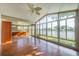 Enclosed sunroom with ample windows offering lake views and wood-look flooring at 913 El Rancho Dr, Sun City Center, FL 33573