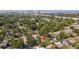 Aerial view showing neighborhood, landscaping, and the city skyline in the distance at 918 E 24Th Ave, Tampa, FL 33605