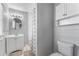 Clean bathroom featuring a vanity, round mirror, and a shower with a patterned curtain at 918 E 24Th Ave, Tampa, FL 33605