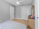 Cozy bedroom with neutral walls, tile flooring, ceiling fan, closet, and dresser at 918 E 24Th Ave, Tampa, FL 33605