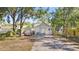 Charming single-story home with a covered entryway, gray exterior, and well-maintained front yard at 918 E 24Th Ave, Tampa, FL 33605