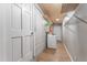 Functional laundry room with a washing machine, storage shelves, and wood-look flooring at 918 E 24Th Ave, Tampa, FL 33605
