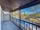 Screened balcony featuring a lovely water view, black railing, and neutral carpeting at 9201 Tudor Dr # C212, Tampa, FL 33615