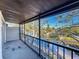 Screened balcony featuring a lovely water view, black railing, and neutral carpeting at 9201 Tudor Dr # C212, Tampa, FL 33615