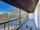 Screened balcony featuring a lovely water view, railing, and neutral carpeting at 9201 Tudor Dr # C212, Tampa, FL 33615