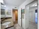 Bathroom featuring granite countertops and access to a closet and walk-in at 9201 Tudor Dr # C212, Tampa, FL 33615