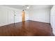 Bright and spacious bedroom with hardwood floors, white walls, and a ceiling fan at 9201 Tudor Dr # C212, Tampa, FL 33615