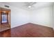 Spacious, bright bedroom with a ceiling fan and hardwood floors at 9201 Tudor Dr # C212, Tampa, FL 33615
