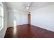 Spacious bedroom with hardwood floors, ceiling fan, and closet at 9201 Tudor Dr # C212, Tampa, FL 33615
