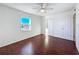 Bright bedroom with hardwood floors, a ceiling fan and double closets, plus a bright window at 9201 Tudor Dr # C212, Tampa, FL 33615