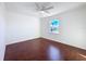 Bright bedroom with hardwood floors, a ceiling fan and a window with scenic views at 9201 Tudor Dr # C212, Tampa, FL 33615