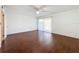 Spacious bedroom with hardwood floors, a ceiling fan, and sliding glass doors to balcony at 9201 Tudor Dr # C212, Tampa, FL 33615