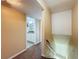 Hallway leading to a bathroom with white vanity and granite counters, plus stairs to another level at 9201 Tudor Dr # C212, Tampa, FL 33615