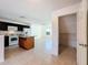 Bright kitchen features an island with granite counters and black cabinets at 9201 Tudor Dr # C212, Tampa, FL 33615