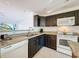 Granite countertops and dark cabinets are visible in this contemporary kitchen at 9201 Tudor Dr # C212, Tampa, FL 33615