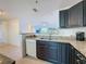 Kitchen with dark cabinetry, granite countertops, and stainless-steel appliances at 9201 Tudor Dr # C212, Tampa, FL 33615