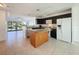 Kitchen area featuring an island with granite countertops and black cabinetry at 9201 Tudor Dr # C212, Tampa, FL 33615