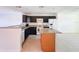 Well-lit kitchen boasts granite countertops, black cabinetry, and a kitchen island at 9201 Tudor Dr # C212, Tampa, FL 33615