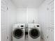 Well-lit laundry room with side by side washer and dryer at 9201 Tudor Dr # C212, Tampa, FL 33615